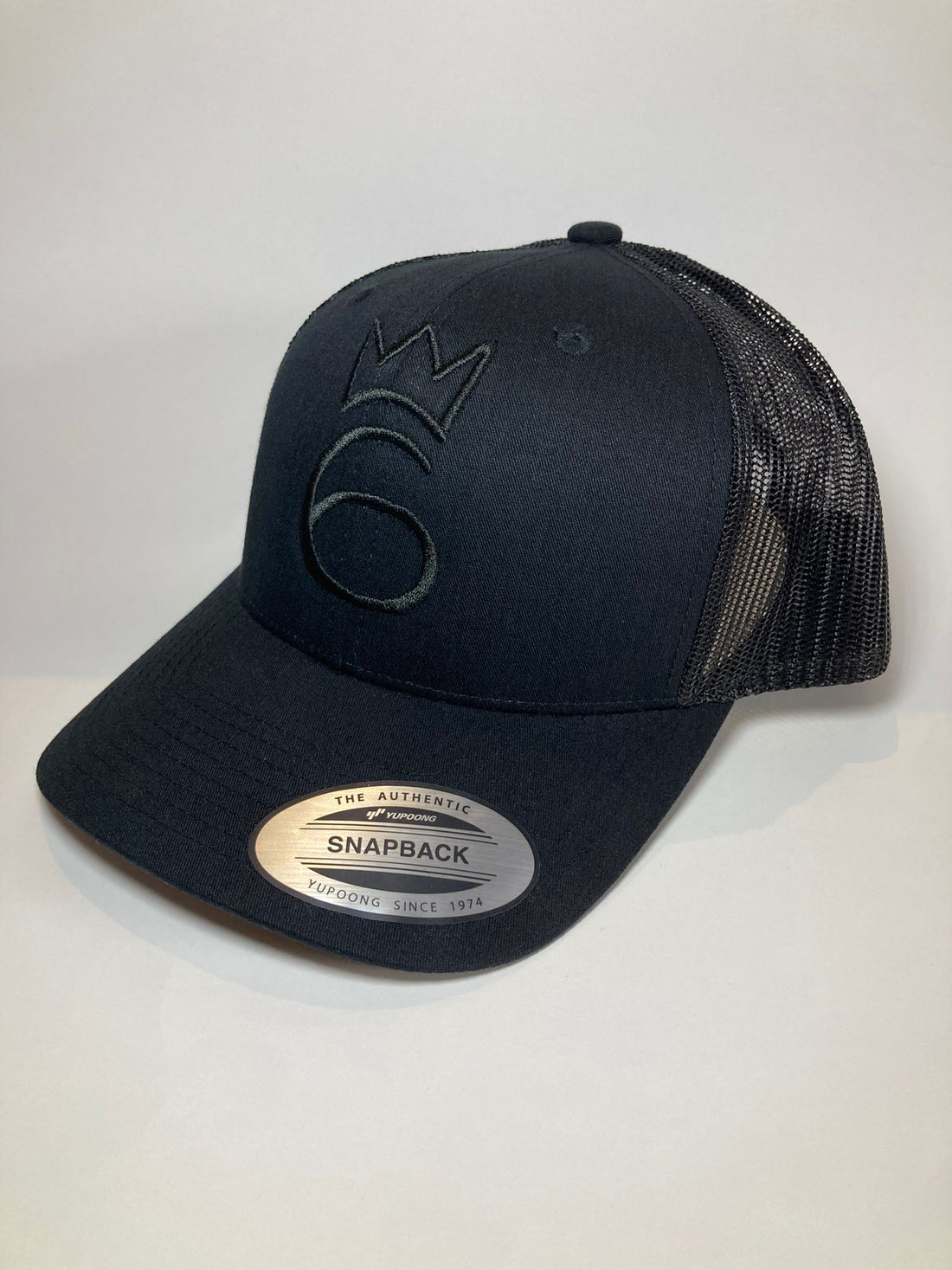 classic lightweight twill cap in black on black with a grey name tag and snapback closure.